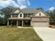 Inviting two-story home featuring a brick facade, covered porch, and well-manicured lawn at 3624 Peeksville Rd, Locust Grove, GA 30248