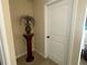 Hallway featuring carpet, a small vase on a stand, beige walls, and white trim at 3624 Peeksville Rd, Locust Grove, GA 30248