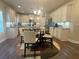 Open-concept kitchen featuring a breakfast nook with chairs, white cabinets, and granite countertops at 3624 Peeksville Rd, Locust Grove, GA 30248