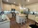 Well-lit kitchen featuring white cabinets, an island with barstools, stainless steel appliances, and granite countertops at 3624 Peeksville Rd, Locust Grove, GA 30248