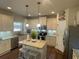 Spacious kitchen featuring white cabinets, an island with seating, stainless steel appliances, and granite countertops at 3624 Peeksville Rd, Locust Grove, GA 30248