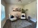 Sitting room with decorative chairs, modern rug, and natural light streaming in at 3624 Peeksville Rd, Locust Grove, GA 30248