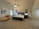 Bright main bedroom features a ceiling fan, neutral walls and carpet, and large bed with bedside tables at 3624 Peeksville Rd, Locust Grove, GA 30248