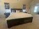 Close up on a large bed in the main bedroom with neutral walls and carpet at 3624 Peeksville Rd, Locust Grove, GA 30248