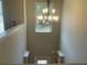 Bright foyer featuring a modern chandelier, natural light, and neutral wall paint at 3624 Peeksville Rd, Locust Grove, GA 30248