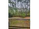 A backyard view from the deck shows tall, lush trees and abundant greenery at 9936 Point Vw, Jonesboro, GA 30238