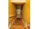 Carpeted stairs lead to the basement featuring yellow walls and a white door and trim at 9936 Point Vw, Jonesboro, GA 30238