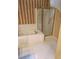 Corner of a bathroom featuring a tiled soaking tub and a glass enclosed shower stall at 9936 Point Vw, Jonesboro, GA 30238