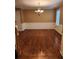 Dining room with chair rail molding, hardwood floors, and a chandelier at 9936 Point Vw, Jonesboro, GA 30238
