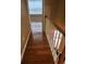 View of upstairs hallway showcasing wood floors and a white bannister with wood railing at 9936 Point Vw, Jonesboro, GA 30238
