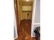 A practical laundry area with overhead cabinets and wood flooring at 9936 Point Vw, Jonesboro, GA 30238