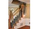 Carpeted staircase with wooden railings, wainscotting, and trim at 9936 Point Vw, Jonesboro, GA 30238