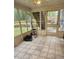 Bright sunroom with tiled flooring and large windows providing abundant natural light and views of the backyard at 9936 Point Vw, Jonesboro, GA 30238