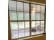 A window showing a sunroom with tiled floor offering natural light and backyard views at 9936 Point Vw, Jonesboro, GA 30238