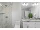Bright bathroom featuring a large walk-in shower, double sink vanity with granite countertop at 1272 Hardee Ne St, Atlanta, GA 30307