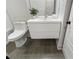 Contemporary bathroom featuring a toilet and sink vanity with white drawers and silver hardware at 1272 Hardee Ne St, Atlanta, GA 30307