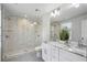 Beautiful bathroom featuring a large shower with tile surround, double sink vanity with granite countertop at 1272 Hardee Ne St, Atlanta, GA 30307