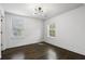 Clean bedroom with two windows for natural lighting, dark wood floors and neutral paint at 1272 Hardee Ne St, Atlanta, GA 30307
