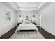 Spacious bedroom featuring tray ceiling, hardwood floors, pendant lighting and modern decor at 1272 Hardee Ne St, Atlanta, GA 30307