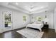 Relaxing bedroom with hardwood floors, recessed lighting and white walls plus access to a backyard space at 1272 Hardee Ne St, Atlanta, GA 30307