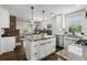 Spacious kitchen with granite countertops, stainless appliances, and white cabinetry with a brick accent wall at 1272 Hardee Ne St, Atlanta, GA 30307