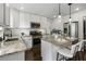 Well-lit kitchen featuring white cabinets, granite countertops, and a stainless steel appliance suite at 1272 Hardee Ne St, Atlanta, GA 30307
