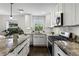 Bright kitchen featuring granite counters, stainless steel appliances and white cabinets at 1272 Hardee Ne St, Atlanta, GA 30307