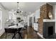 Modern kitchen featuring white cabinets, stainless steel appliances, and a brick fireplace at 1272 Hardee Ne St, Atlanta, GA 30307
