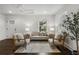 Bright living room featuring hardwood floors, neutral furniture, and a contemporary ceiling fan at 1272 Hardee Ne St, Atlanta, GA 30307