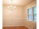 Bright dining room featuring hardwood floors, a modern window and a chandelier at 6470 Sherwood Trl, Austell, GA 30168