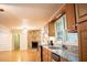 Kitchen and living room view featuring a stone fireplace and granite countertops at 6470 Sherwood Trl, Austell, GA 30168