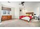 Cozy bedroom with wood-frame bed, carpeted floor, ceiling fan and natural light from large window at 8 Alston Ne Pl, Atlanta, GA 30324