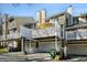 Townhouse-style condos with individual garages and balconies showcasing a contemporary design under a clear sky at 8 Alston Ne Pl, Atlanta, GA 30324