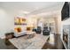 Bright living room featuring hardwood floors, neutral paint, fireplace, and access to a private outdoor patio at 8 Alston Ne Pl, Atlanta, GA 30324