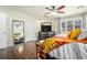 Main bedroom with hardwood floors, ceiling fan, and a large mirror at 8 Alston Ne Pl, Atlanta, GA 30324