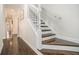 Hardwood staircase with white banister and trim, leading to the upper level of the home at 8 Alston Ne Pl, Atlanta, GA 30324