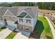 Aerial view of two-story home with gray siding, brick accents, well-manicured lawn, and attached two-car garage at 161 Stanchion Dr, Union City, GA 30291