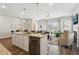 Open floor plan view of kitchen with stainless appliances and island flowing to dining and living room at 161 Stanchion Dr, Union City, GA 30291