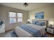 Cozy bedroom featuring a plush bed with blue accents and natural lighting at 26 Loyd Cemetery Rd, Newborn, GA 30056