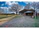 View of the home with a covered carport, and natural views at 26 Loyd Cemetery Rd, Newborn, GA 30056