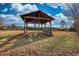 A wooden gazebo with wooden benches on a property with a sprawling lawn at 26 Loyd Cemetery Rd, Newborn, GA 30056