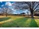 Sprawling green grounds with mature trees and a covered structure in the distance, perfect for outdoor gatherings at 26 Loyd Cemetery Rd, Newborn, GA 30056