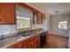 Functional kitchen with a stainless steel sink and wood cabinetry at 26 Loyd Cemetery Rd, Newborn, GA 30056