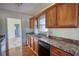 Traditional eat-in kitchen with wood cabinets and stainless steel dishwasher at 26 Loyd Cemetery Rd, Newborn, GA 30056