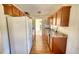 Galley-style kitchen with wood cabinets and modern appliances at 26 Loyd Cemetery Rd, Newborn, GA 30056