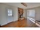 Cozy living room featuring a brick fireplace and wood laminate flooring at 26 Loyd Cemetery Rd, Newborn, GA 30056