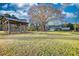 Scenic view of a house, a gazebo and a carport, set on expansive green lawns at 26 Loyd Cemetery Rd, Newborn, GA 30056