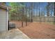 A fenced backyard with a concrete patio and mature trees in the background at 28 Eagle Glen Ne Dr, Cartersville, GA 30121