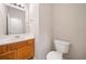 Well-lit half bathroom features tile flooring and a wood vanity at 28 Eagle Glen Ne Dr, Cartersville, GA 30121