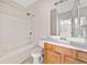 Bathroom features shower-tub combo, white tile, and light-wood vanity cabinet at 28 Eagle Glen Ne Dr, Cartersville, GA 30121